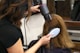 woman holding white and black hair blower