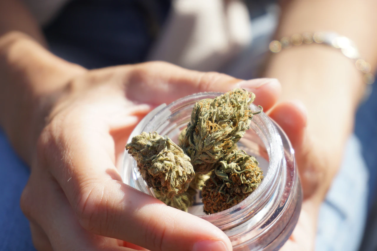 Cannabis flower in a clear glass jar, the kind of product listing a live online menu has to keep accurate