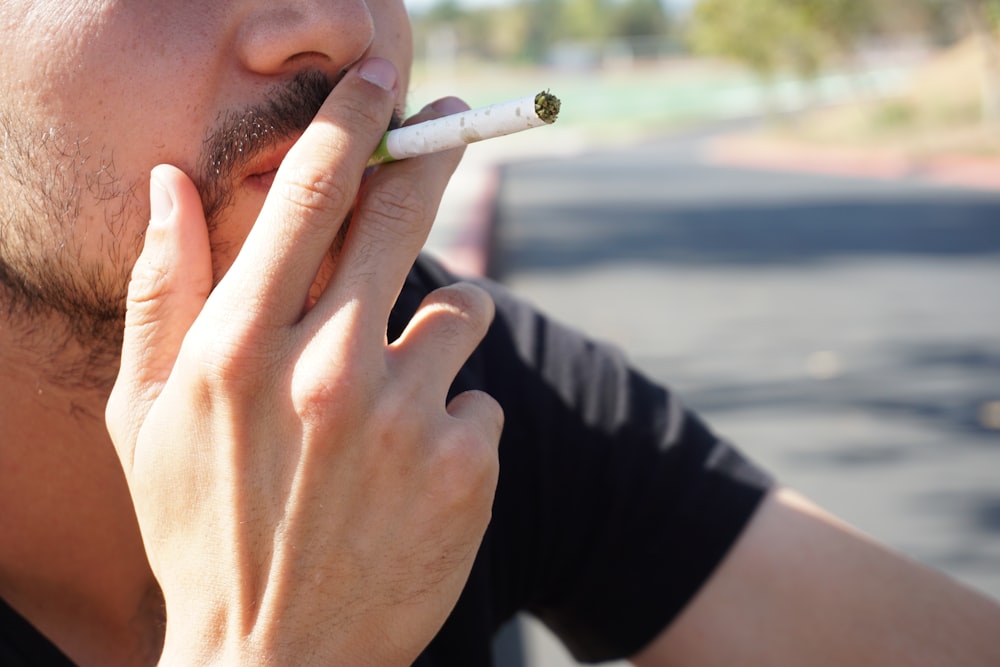 man smoking cigarette during daytime