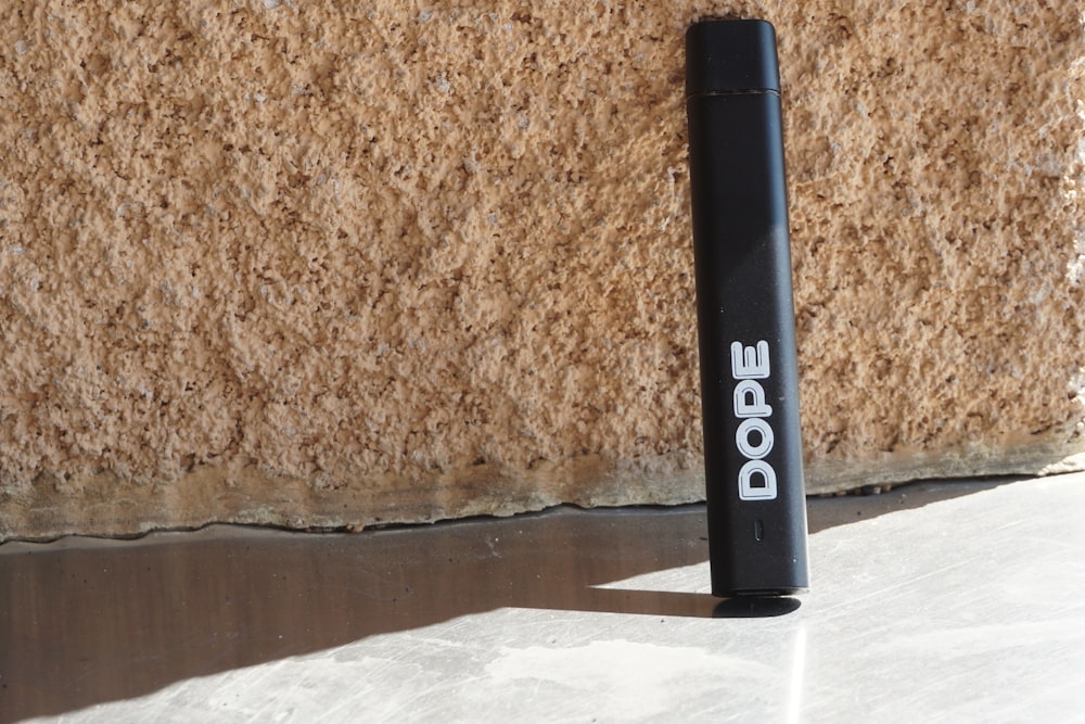 black tube type vaporizer on brown marble table