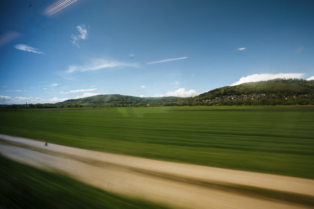 green grass field under blue sky during daytime