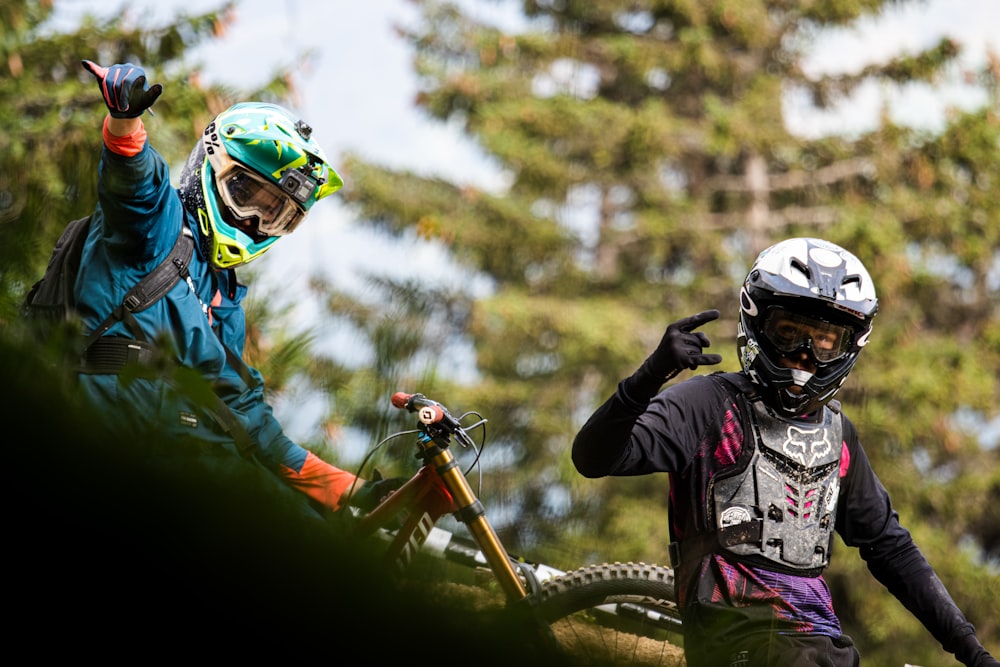 man in green and white jacket riding on orange and black motocross dirt bike