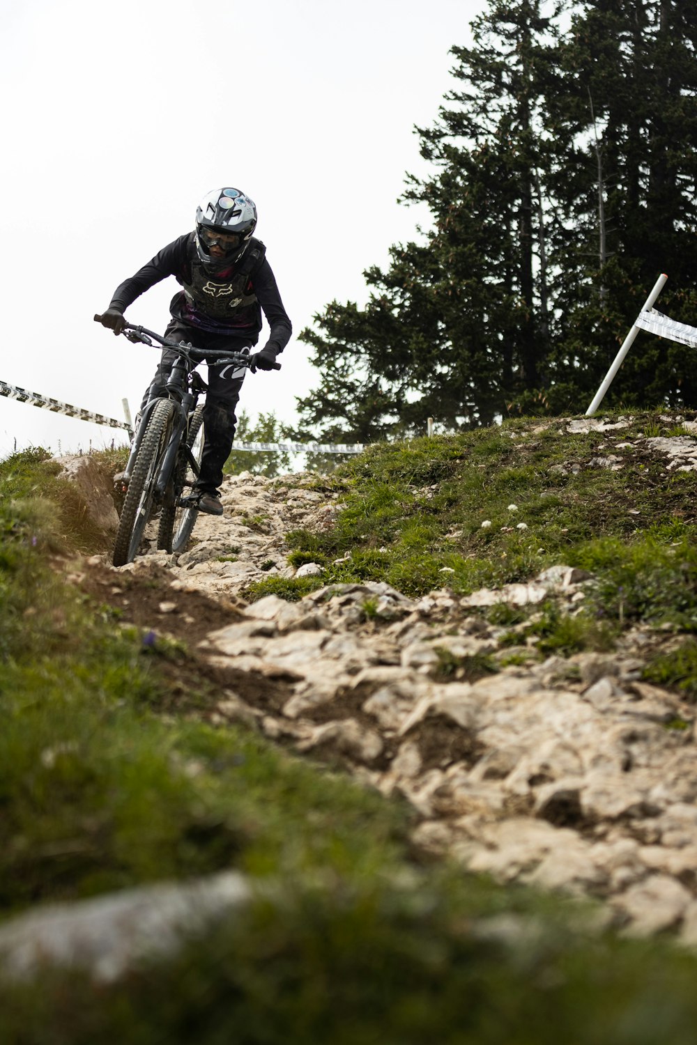 man in black helmet riding on mountain bike during daytime