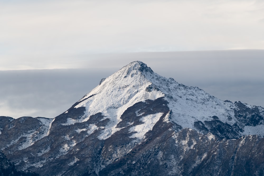 snow covered mountain under cloudy sky during daytime