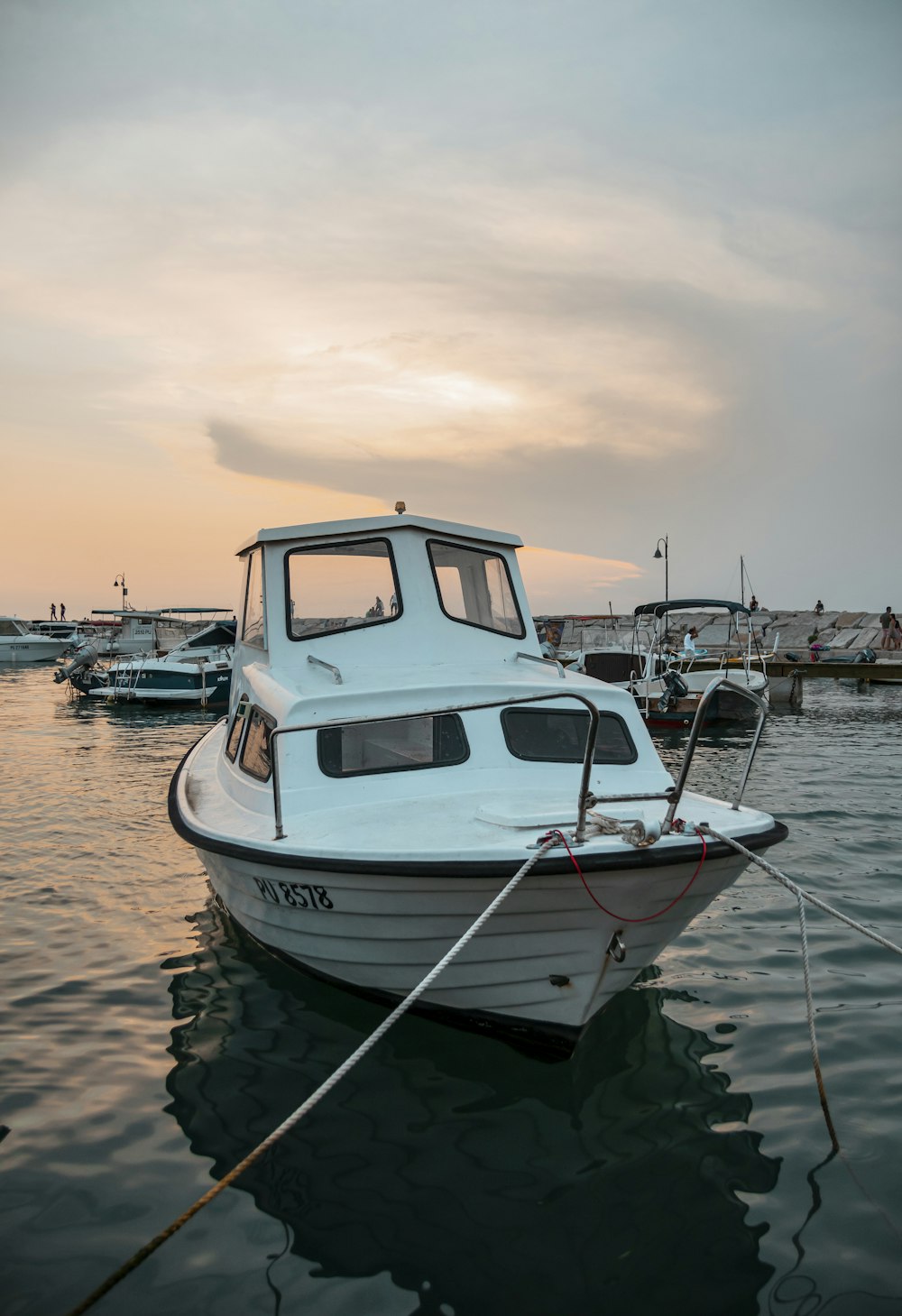 white and blue boat on water during daytime