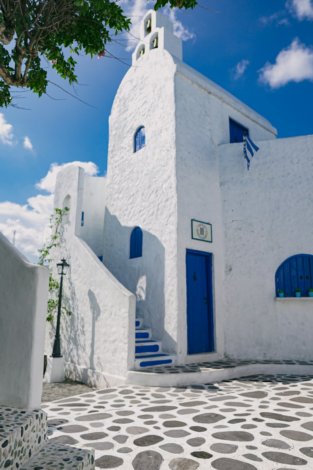 blue wooden door on white concrete building