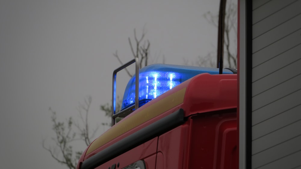 red bus on road during daytime