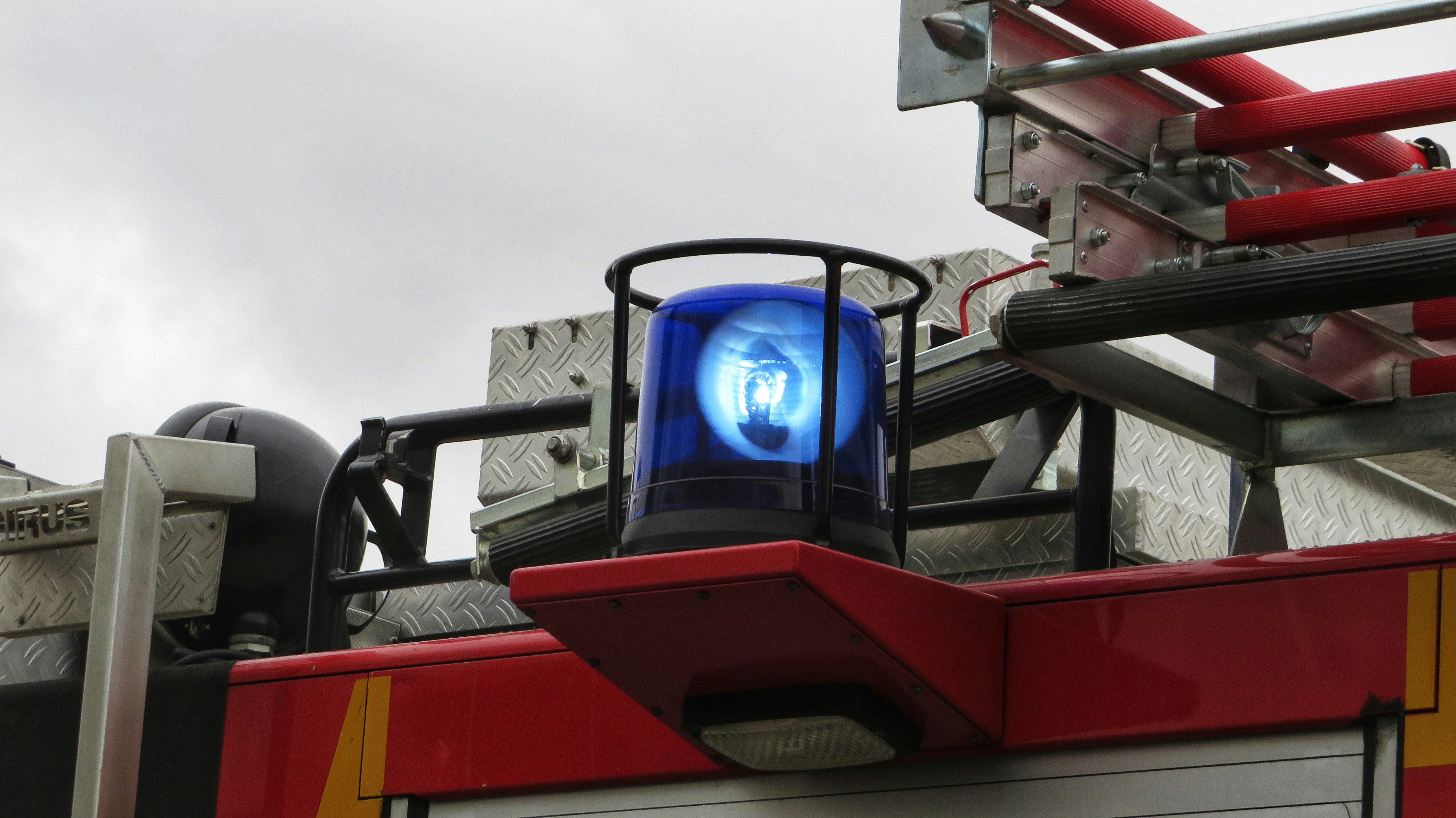 A firetruck lights up for a car crash film scene, which will use royalty free siren sound effects including ambulance sound effects and a police siren sound download