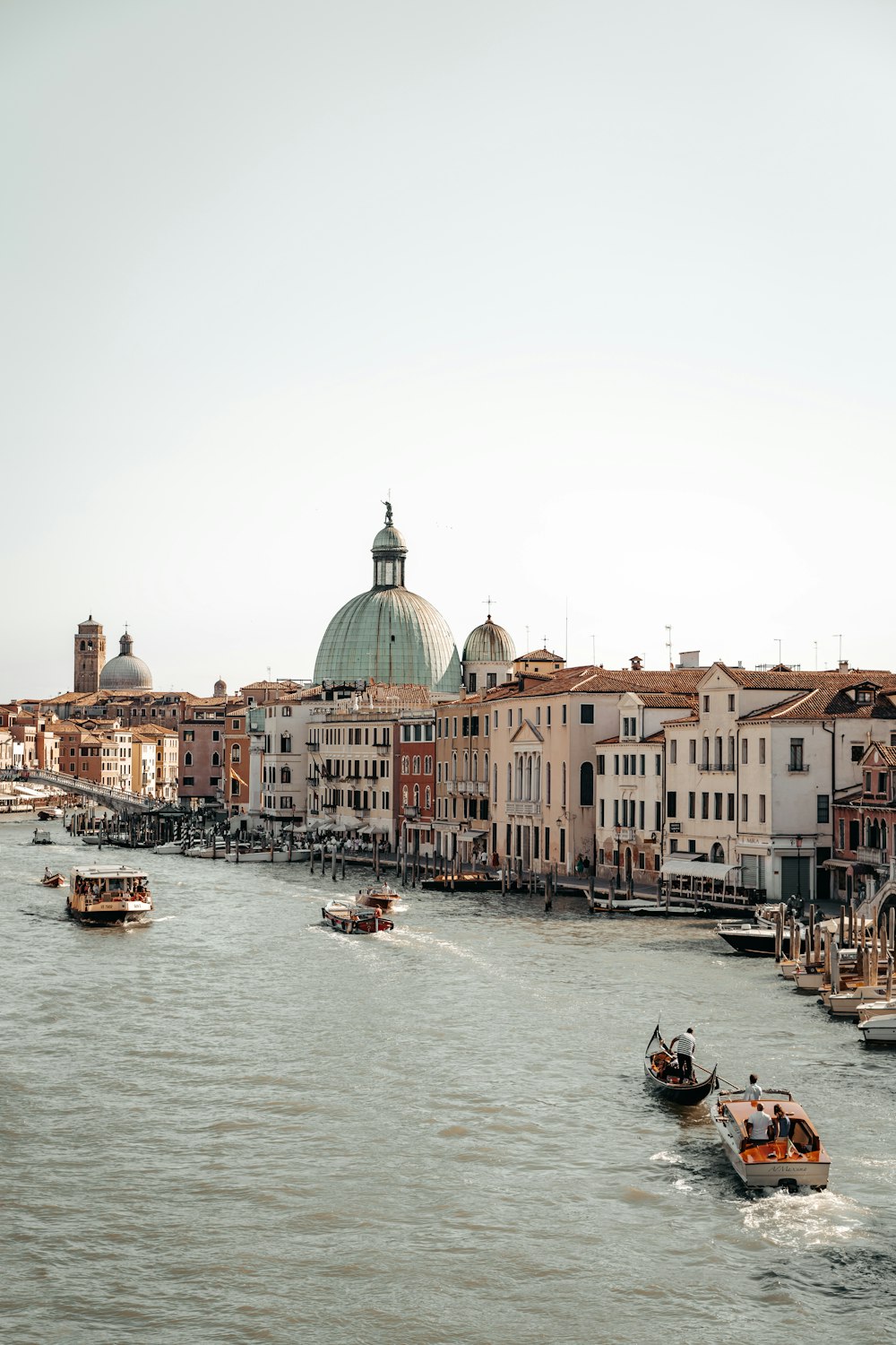 people riding on boat on river near buildings during daytime