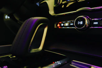 Close-up of a sleek car multimedia system glowing in a dark interior
