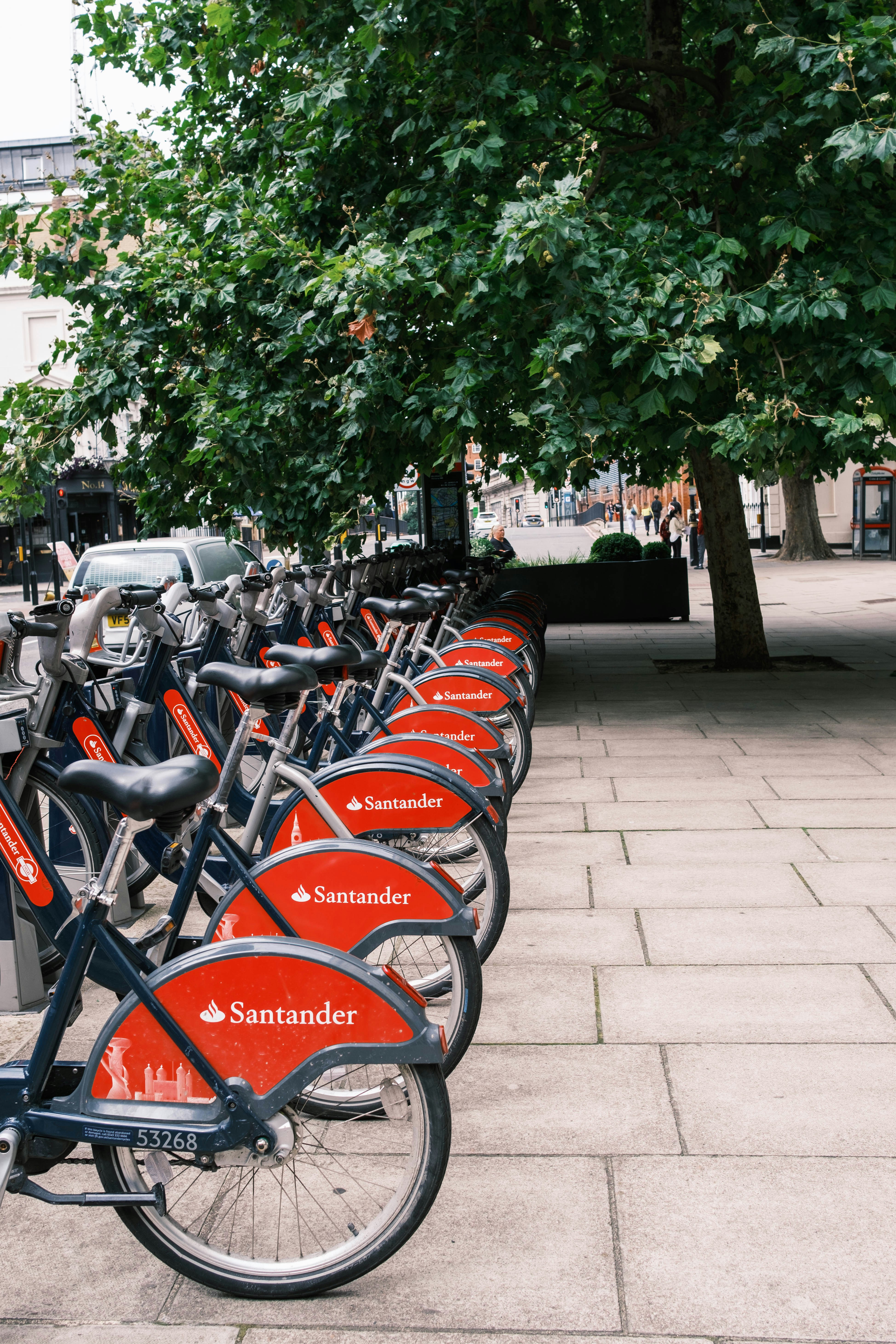 santander cycles parked on pavement during daytime
