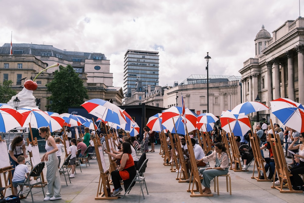people sitting on chairs under umbrella during daytime