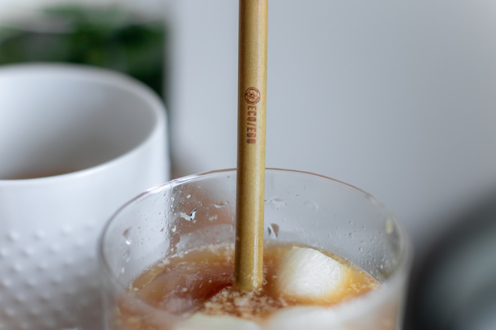 clear drinking glass with brown liquid