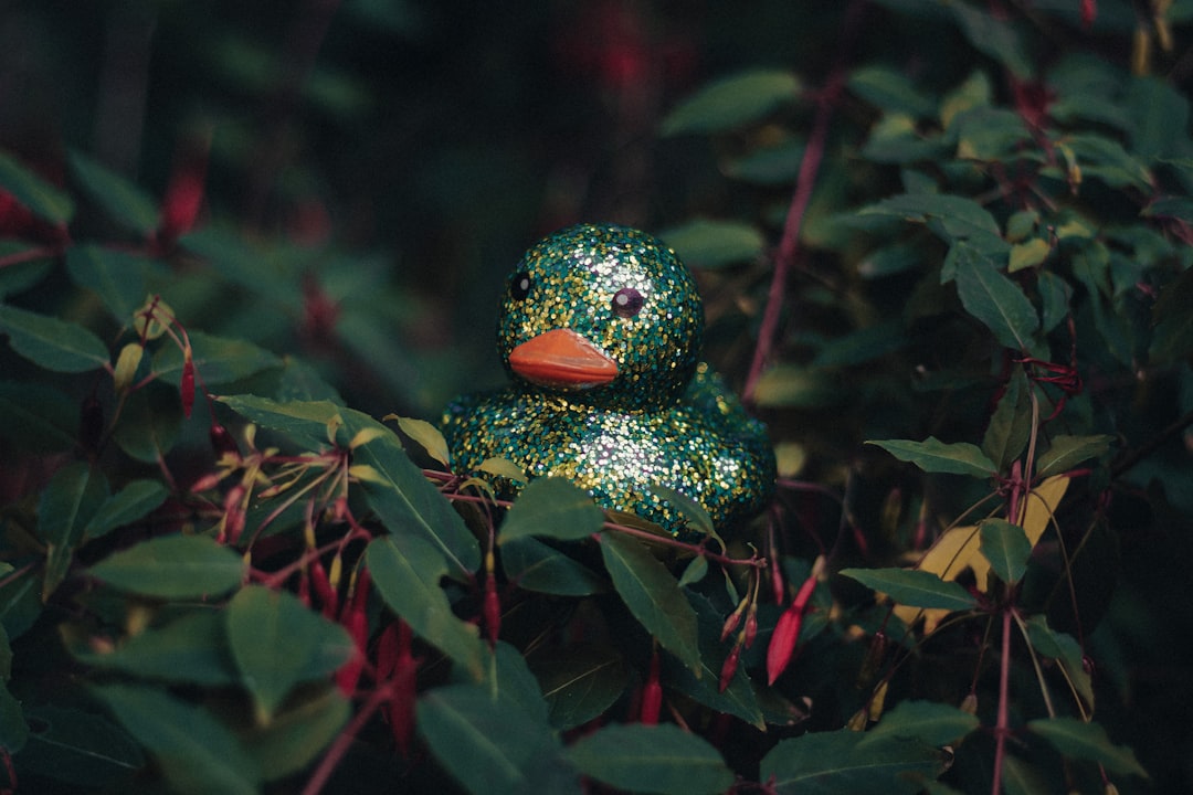 green and brown ceramic bird figurine