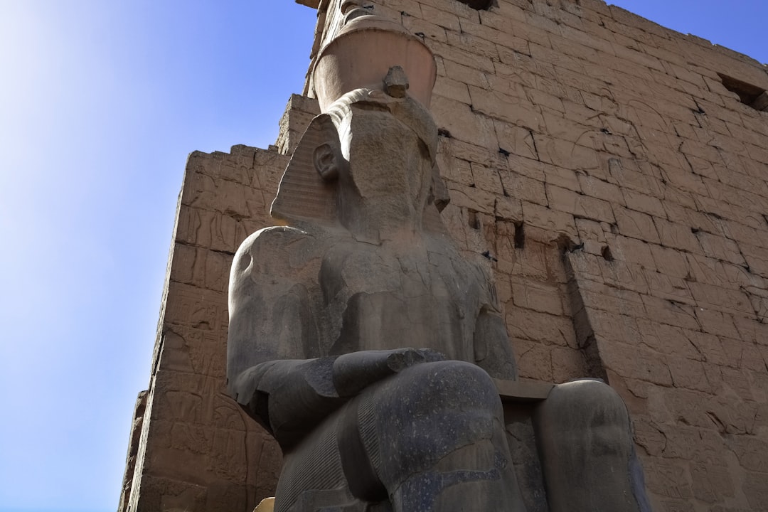 brown concrete statue under blue sky during daytime