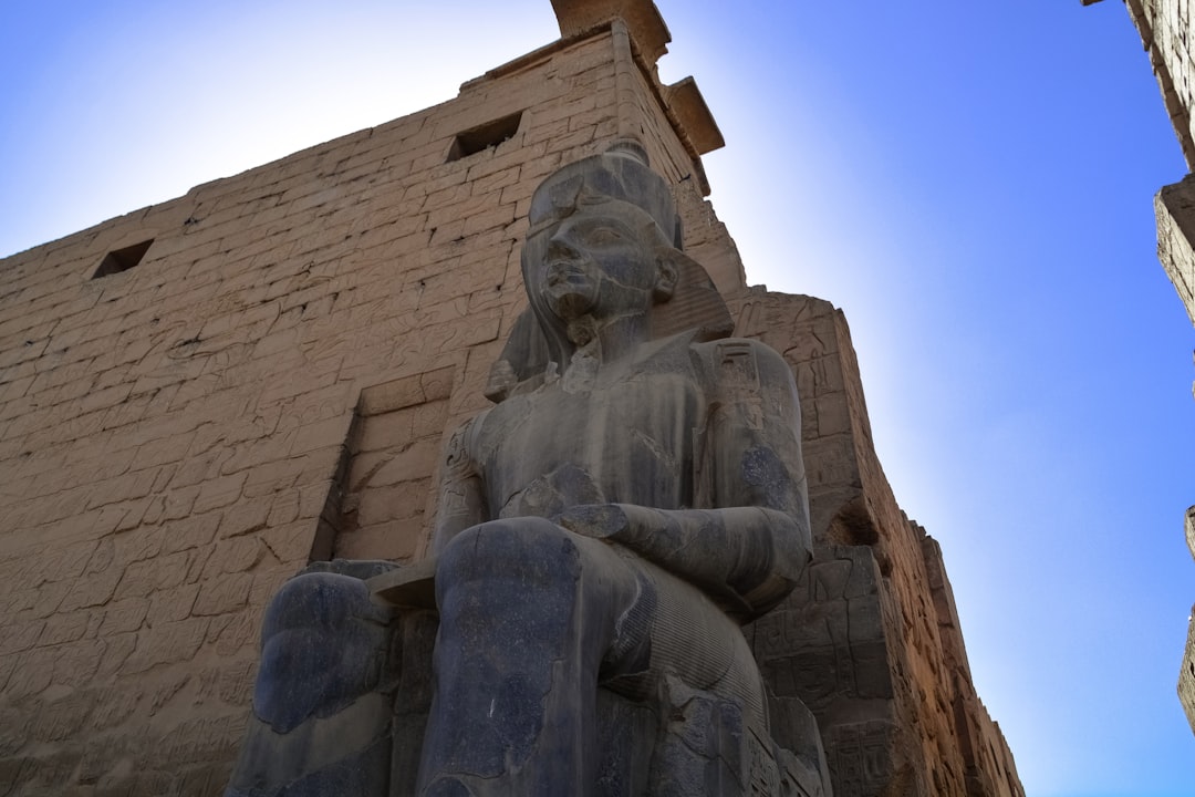 brown concrete statue under blue sky during daytime