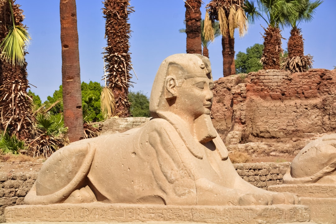 white concrete statue near brown trees during daytime