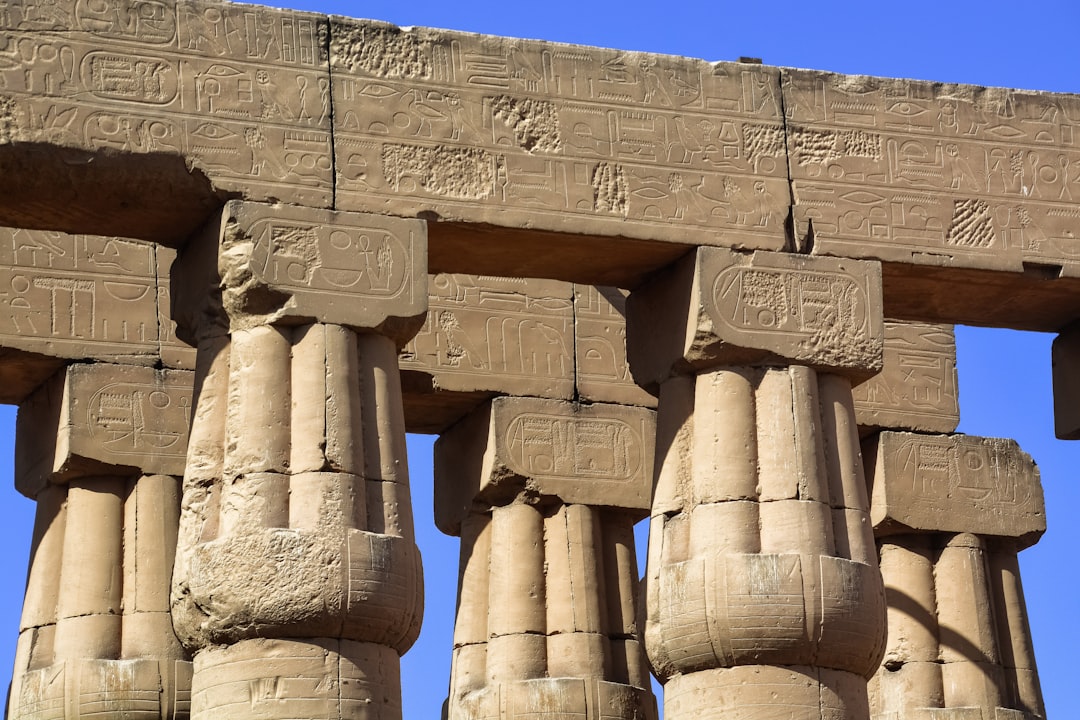 brown concrete statues under blue sky during daytime