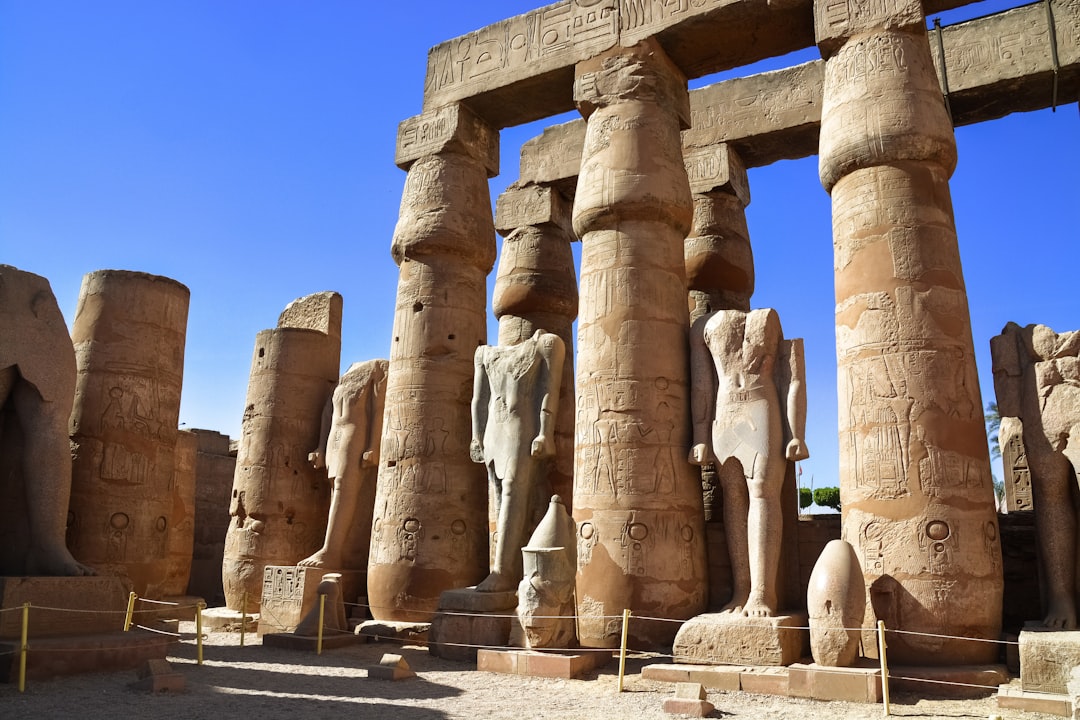 gray concrete statues under blue sky during daytime