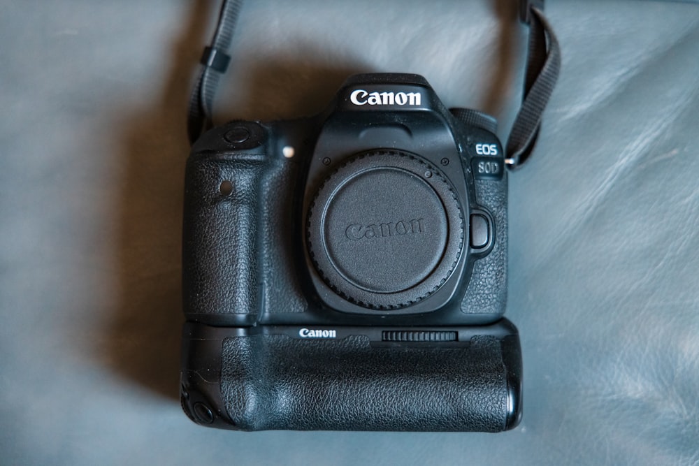 black nikon dslr camera on white table