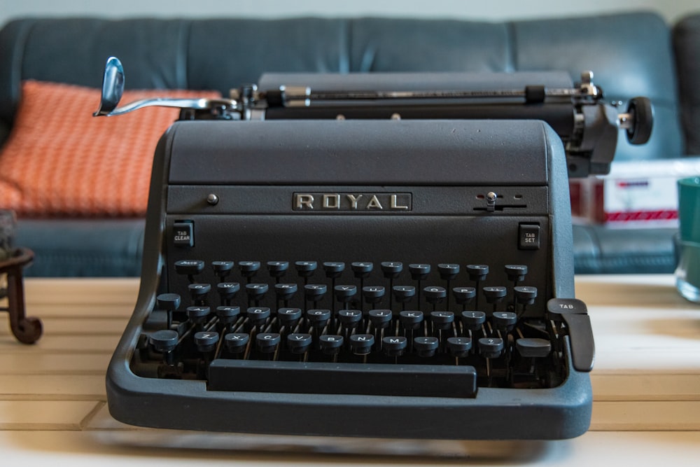 black and gray typewriter on red textile