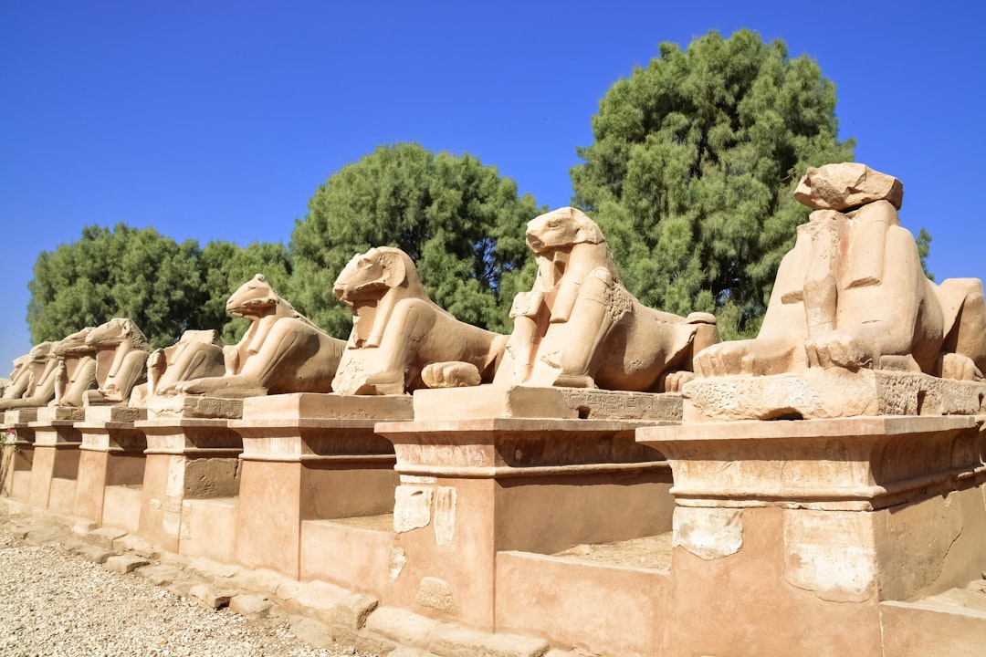 brown concrete statues under blue sky during daytime