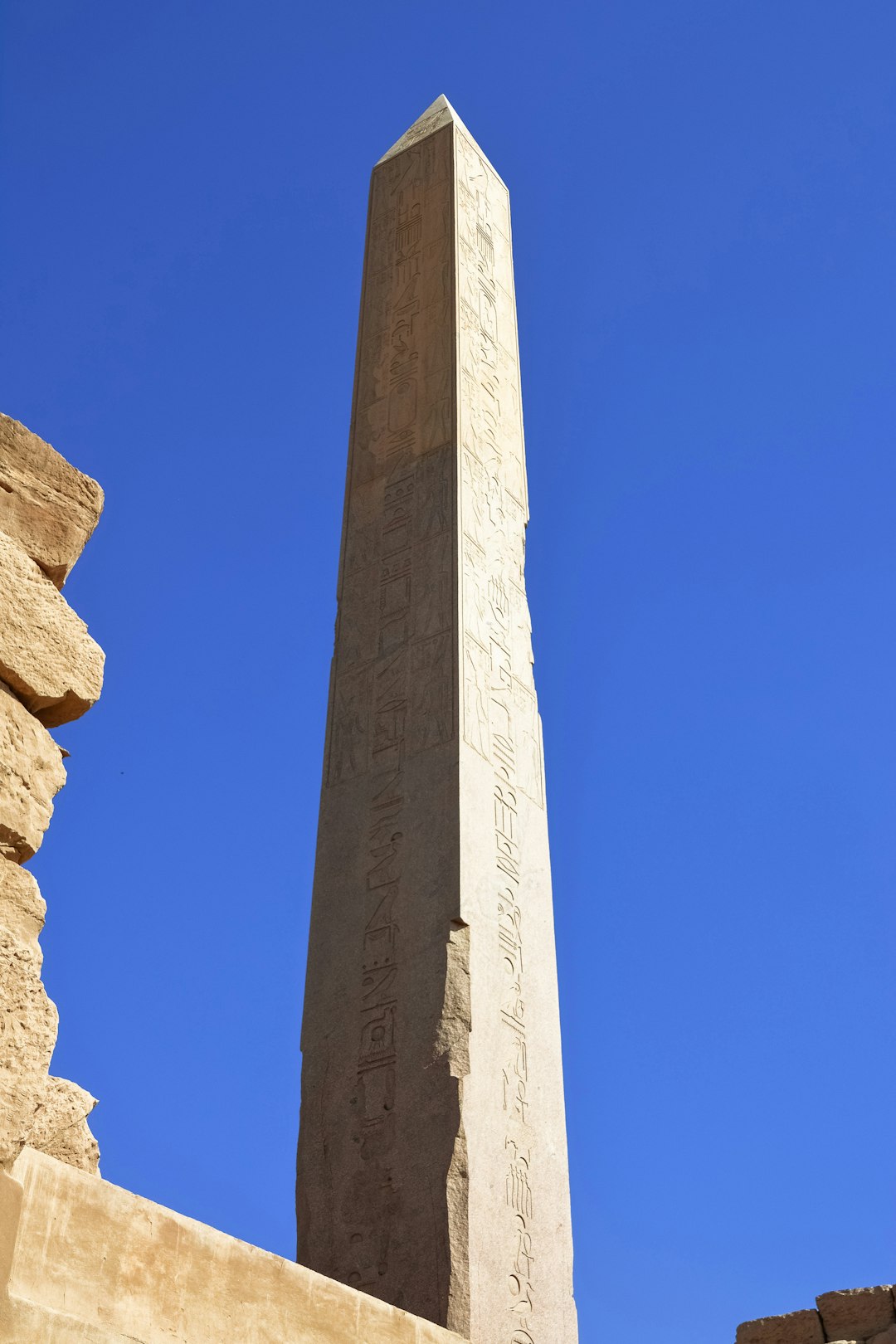 gray concrete cross under blue sky during daytime