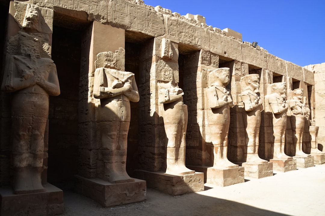 brown concrete statues under blue sky during daytime