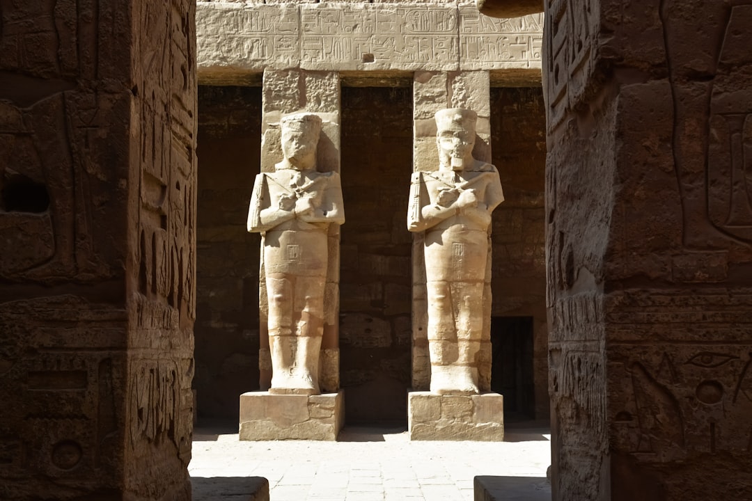 brown concrete statues on brown concrete wall