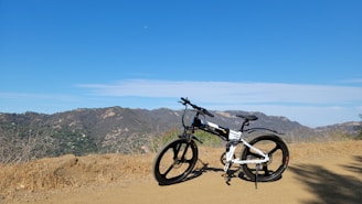 black and gray mountain bike on brown sand during daytime