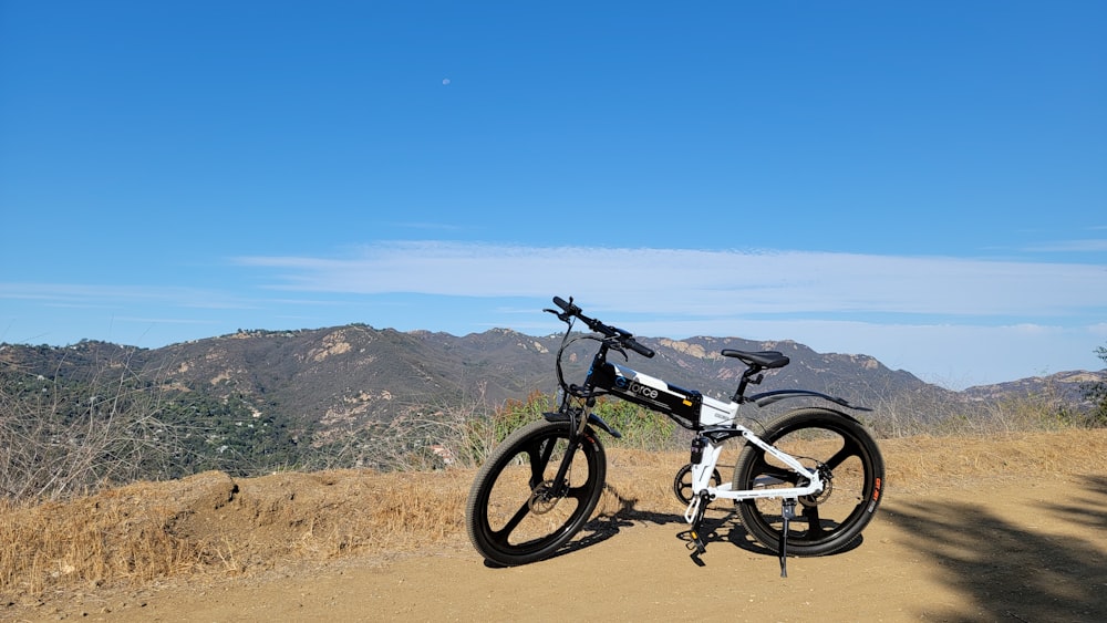 black and gray mountain bike on brown sand during daytime