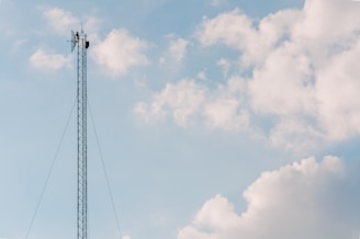 black electric post under cloudy sky during daytime