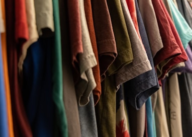 assorted clothes hanged on rack