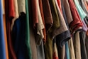 assorted clothes hanged on rack