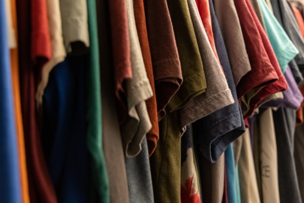 assorted clothes hanged on rack