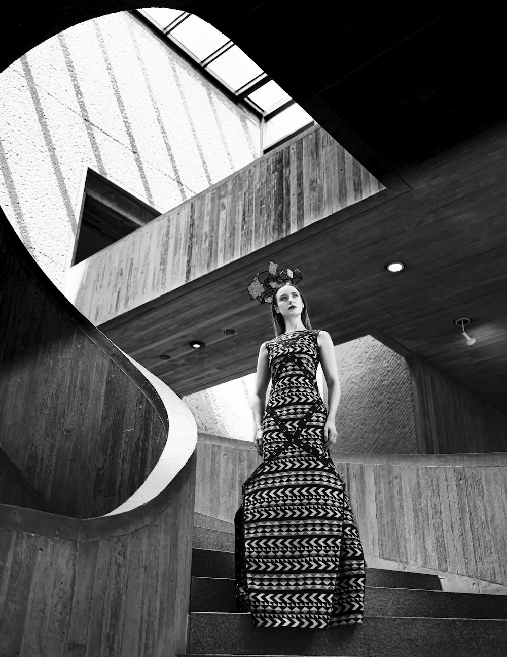 a woman in a dress is standing on some stairs