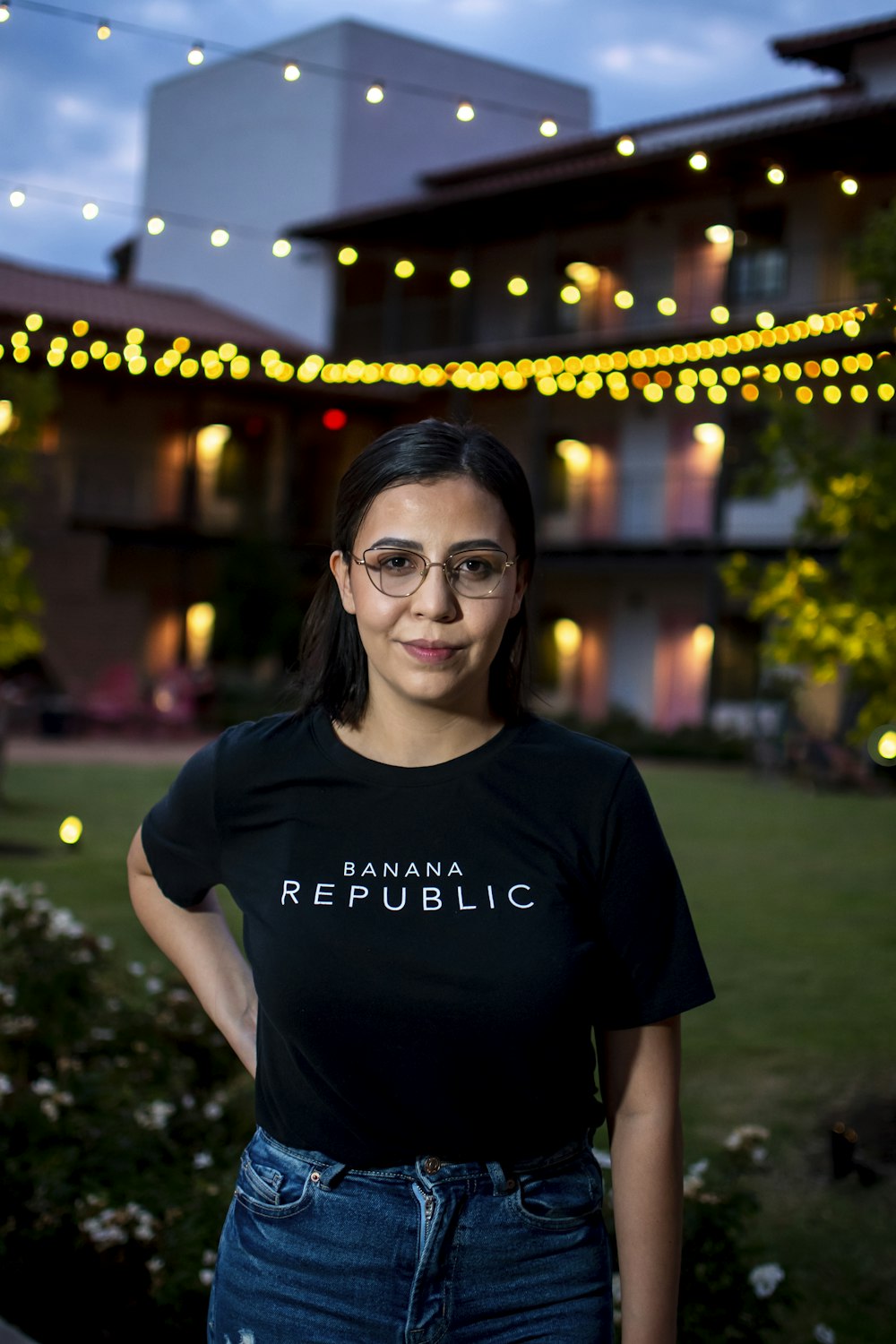 smiling woman in black crew neck t-shirt wearing black framed eyeglasses