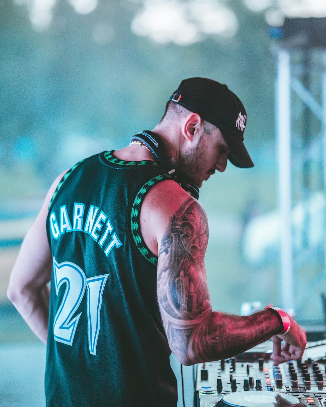 man in black and white nike tank top wearing black baseball cap