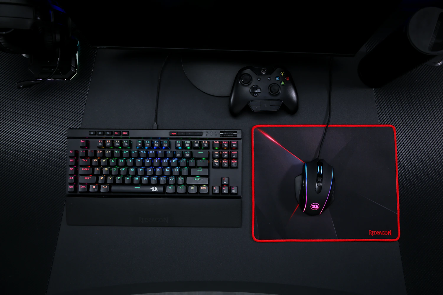 Gaming headset and RGB desk equipment in a dark esports setup