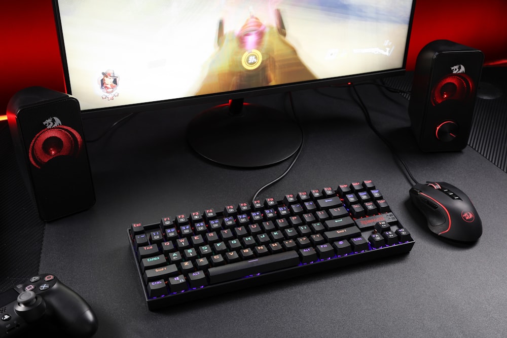 black computer keyboard beside black flat screen computer monitor