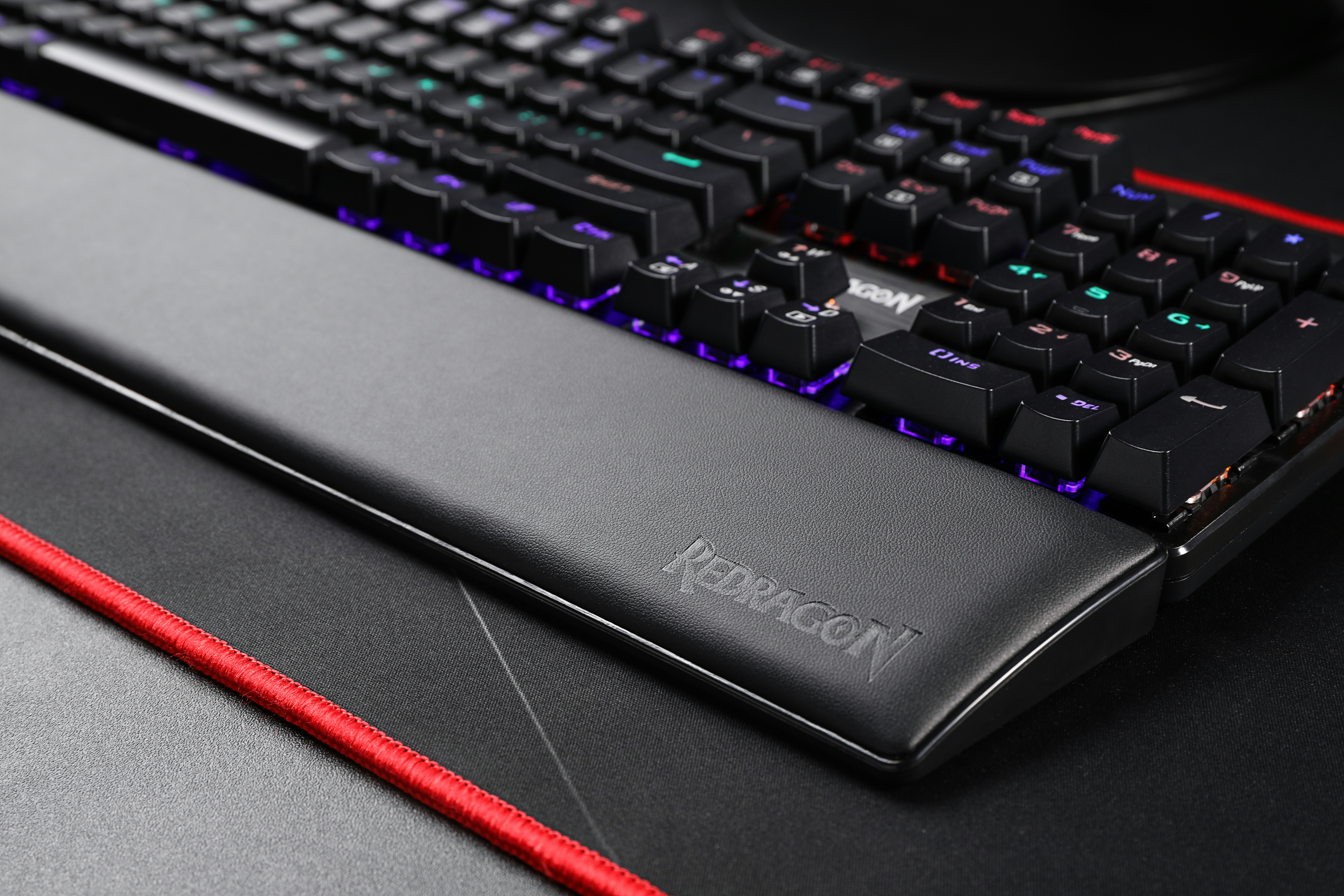 black computer keyboard beside red pencil