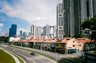 A vibrant cityscape of Singapore blending modern skyscrapers with traditional shophouses under a clear sky