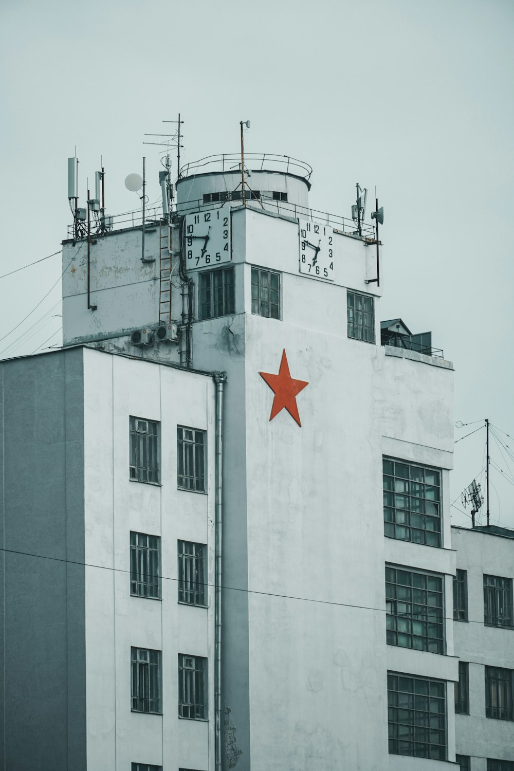 white concrete building with red star flag