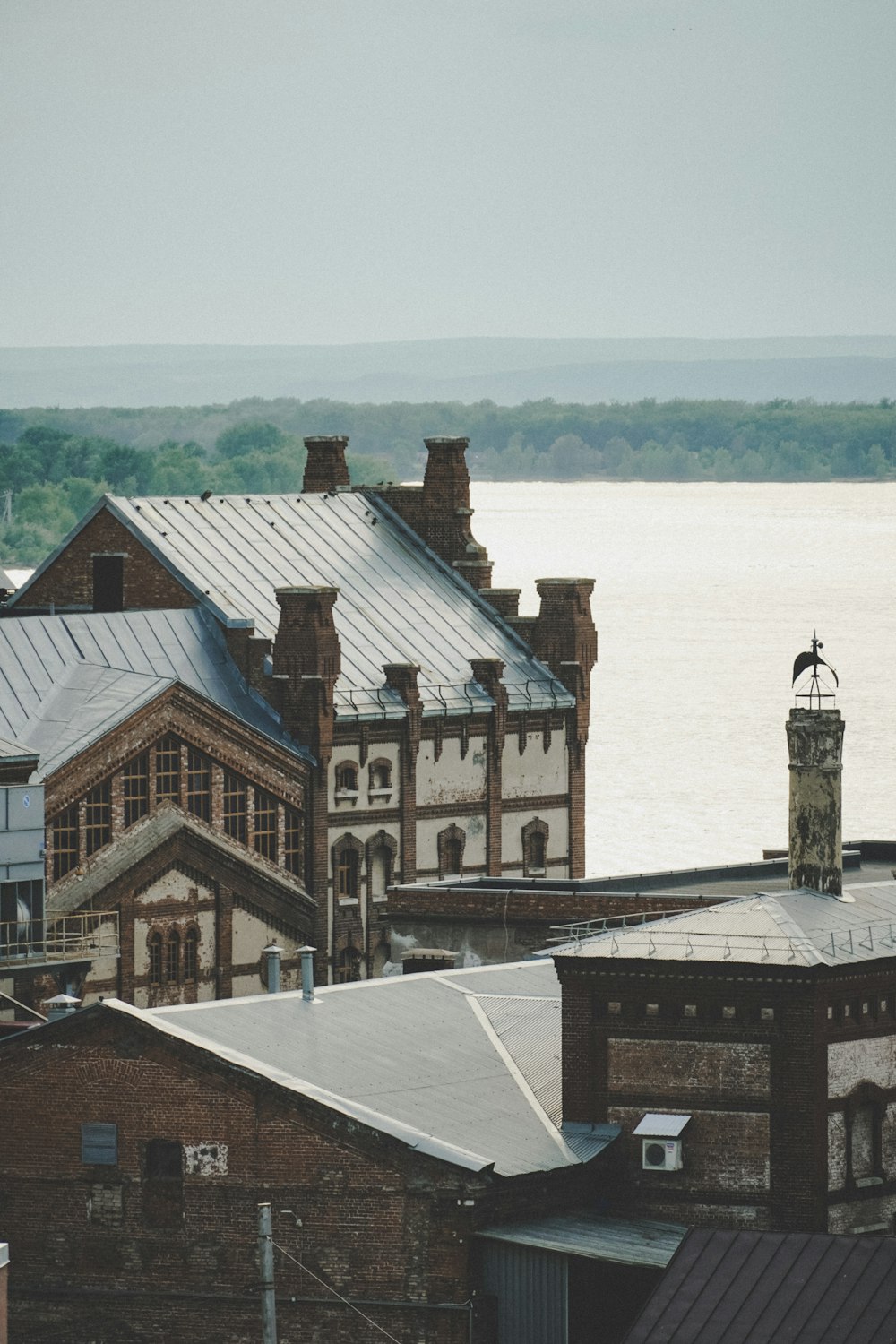 brown and white concrete building near body of water during daytime