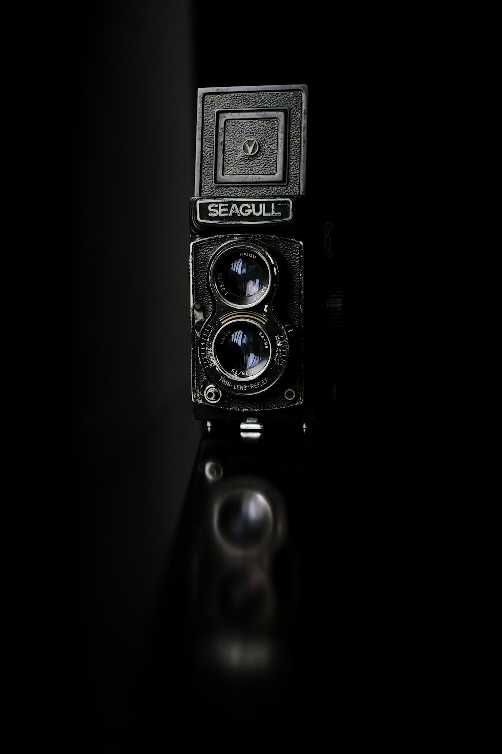black and silver camera in black background