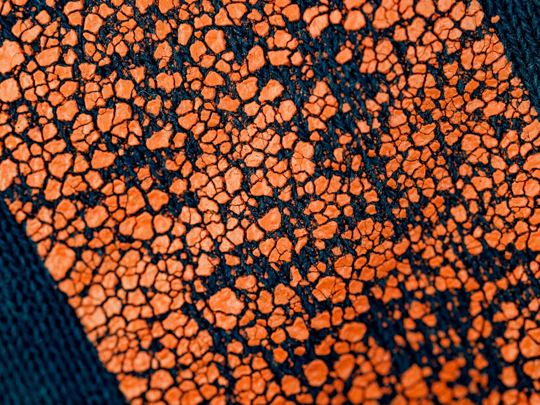 orange and black textile in close up photography