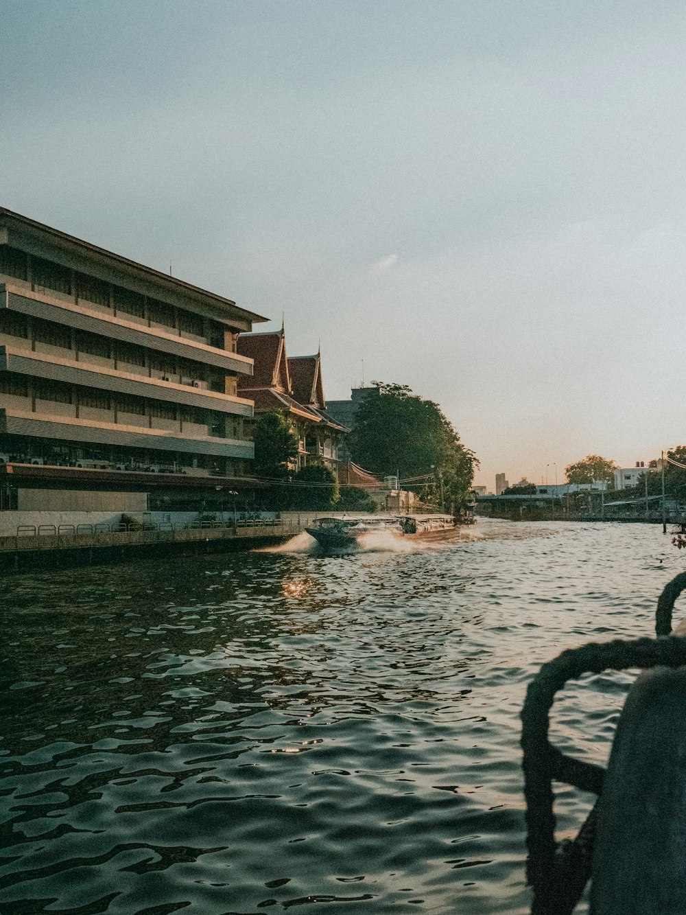 brown concrete building near body of water during daytime