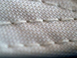 A close-up of intricate stitching on a fashionable garment.