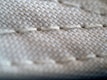 Detailed shot of durable stitching on bedding, emphasizing quality and resistance to pilling.