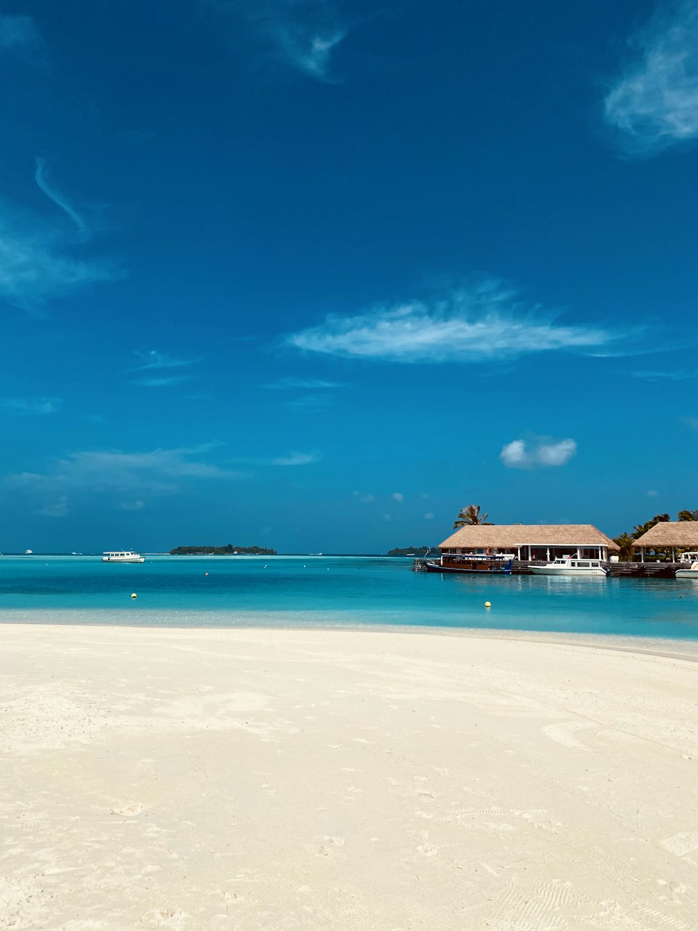 brown wooden house on beach during daytime